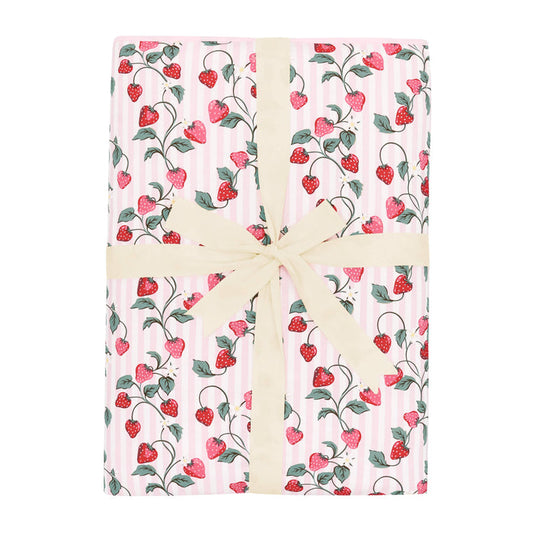 Youth Blanket in Strawberry Fields 2.5 shown in its packaging tied with a linen bow