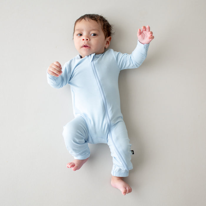 Baby wearing light blue romper with zipper
